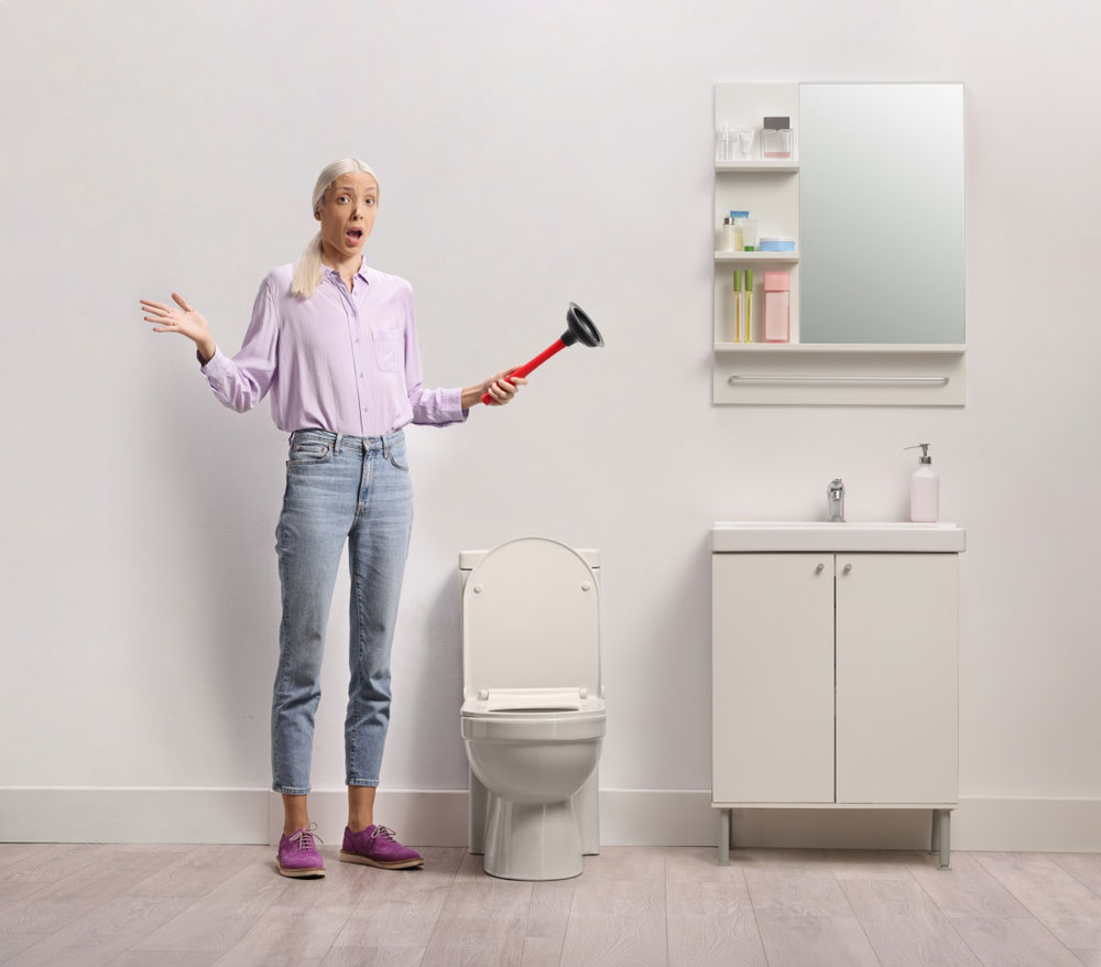 a frustrated person giving up on a clogged drain